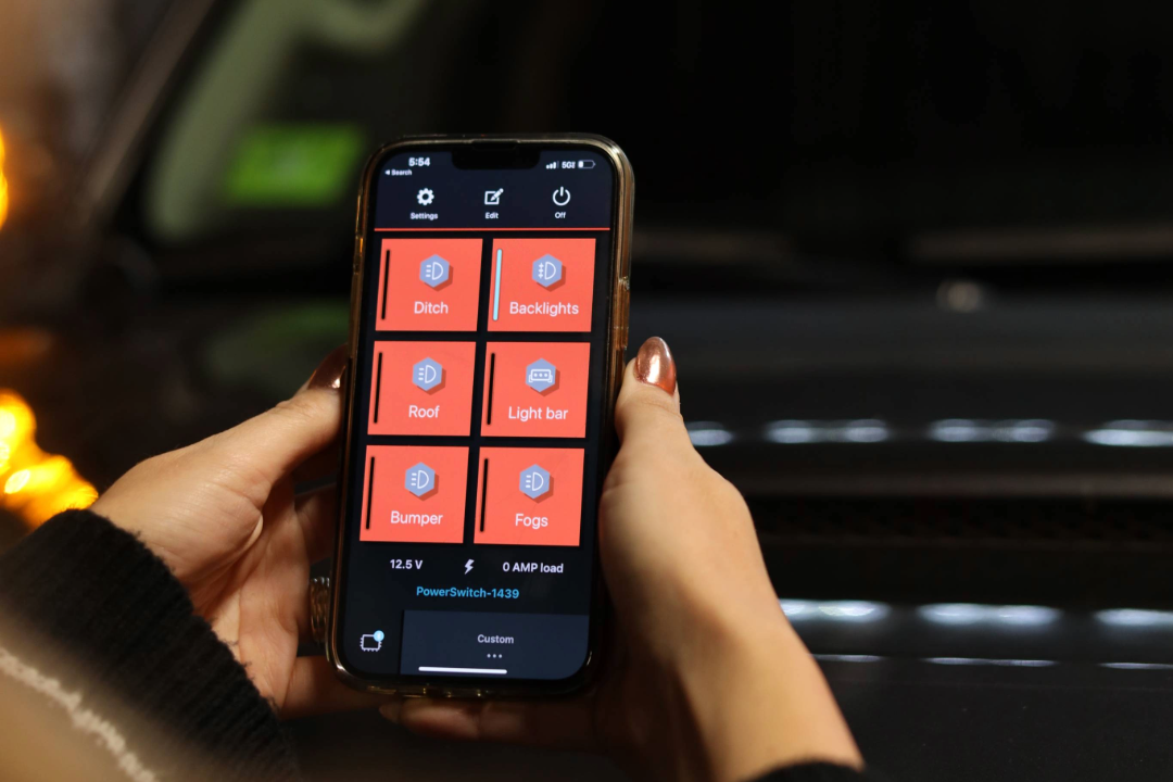 Person using a smartphone app to control car lights inside a vehicle